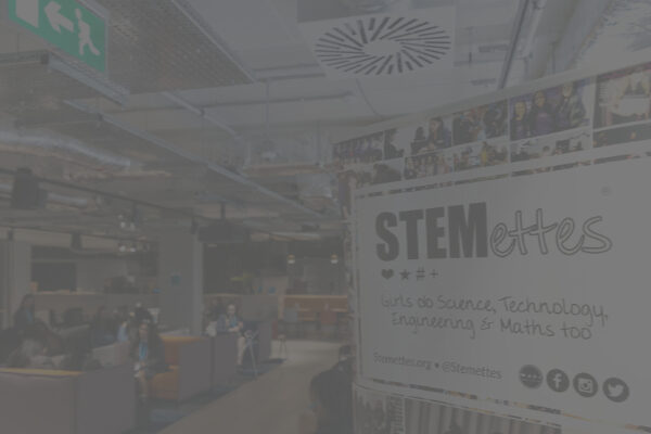A Stemettes event banner in an event room. Image has a grey overlay.