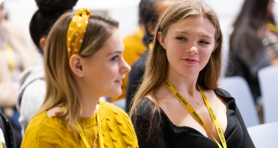 Two girls in STEM talking at an event.