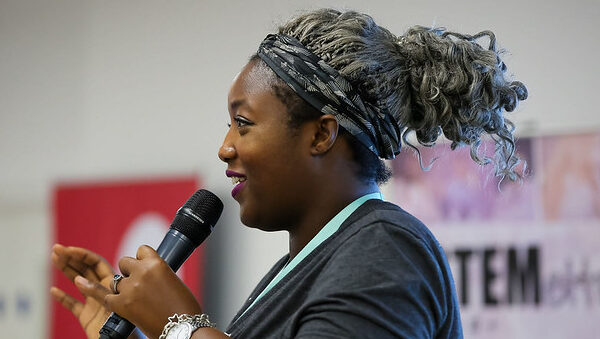 Stemettes CEO, Anne-Marie Imafidon, speaking with a Microphone.