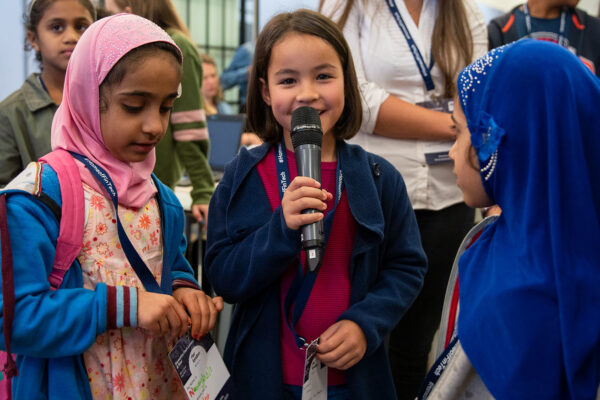 Three Young Stemettes event attendees talking into a microphone.
