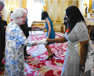 Head Stemette Anne-Marie meeting the Queen in a decorated room.