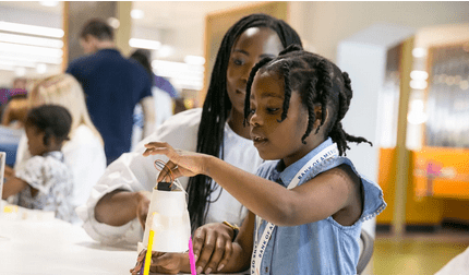 A parent and child working on a project at a Stemettes event.