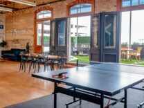 Donate - An open plan space with a Table Tennis Table and set of table and chairs