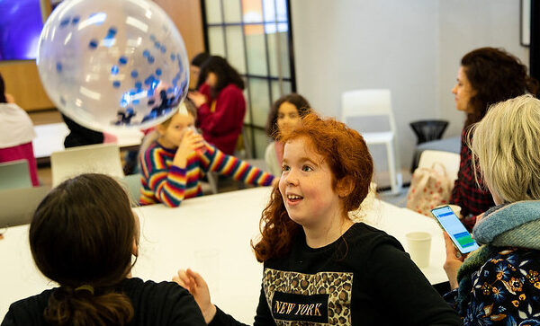 A table of people at a Stemettes event looking at a balloon.