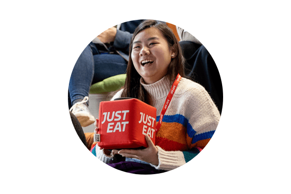 Circular image of a Stemettes attendee holding a Just Eat box.