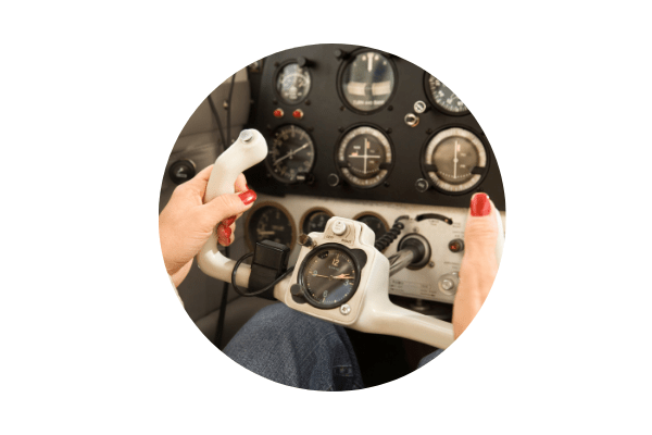 Circular image of hands on a Pilot Steering wheel.