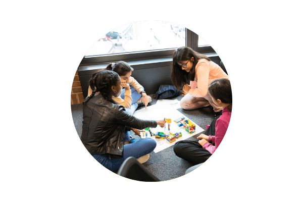 Circular image of Stemettes event attendees playing with lego.