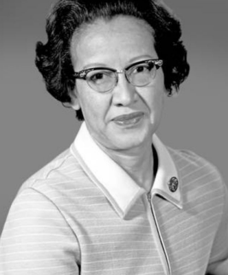 Black and white image of Katherine Johnson wearing a striped shirt smiling in front of a grey background.