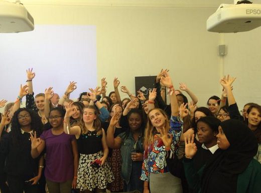 All of the outbox incubator attendees smiling and posing holding up a 'O' shape with their hands.