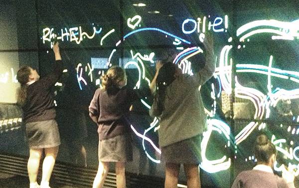 Four Stemettes playing on a large touch screen wall.