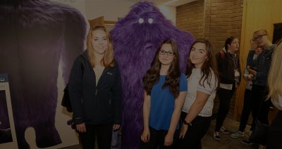 Three Stemettes standing in front of a MonsterConfidence figure.