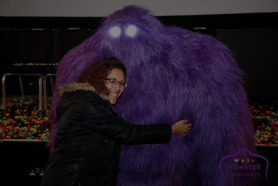 A Stemette hugging a big purple Monster.