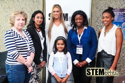 Winner of Stemettes hack standing with five adults in front of a Stemettes banner.