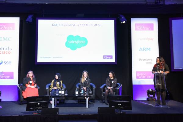 A panel of 4 people and Anne-Marie Imafidon presenting on a stage.