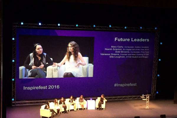 A panel of 6 people on a stage in front of a large screen at Inspirefest 2016.