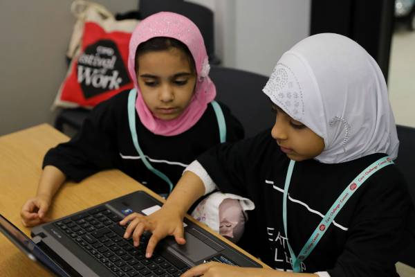 Two Stemettes working together on a laptop.