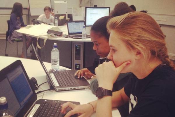 A room of Stemettes with bottles of water working on laptops.