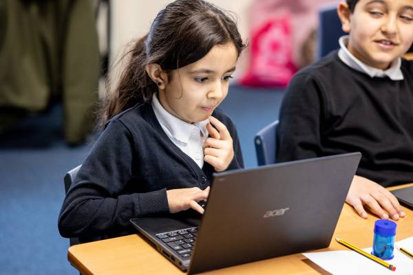 A school Stemette working on a laptop.