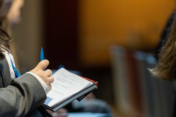 A Stemette taking notes on a pad.