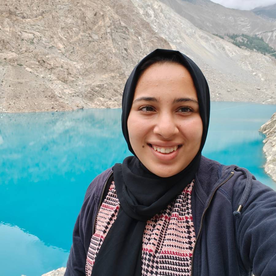 Youth Board Member Neha in front of a blue lake.