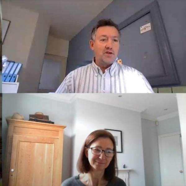 Two people are on a video call. In the top half of the screen is a man wearing a shirt, he has short greyish hair. On the bottom half is a woman wearing a grey top, she has shoulder-length, straight brown hair and is wearing black rectangular glasses.