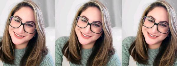 Julia is smiling at the camera. She has long blonde hair and is wearing black square glasses. She is sat in front of a white background. The picture repeats three times next to each other.